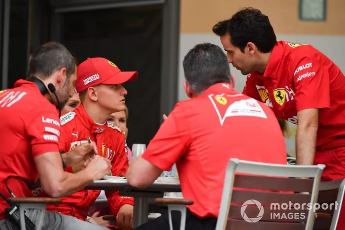Mick Schumacher, Ferrari, sits with the Ferrari team at lunch