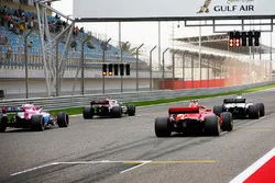 Drivers practice their starts on the grid