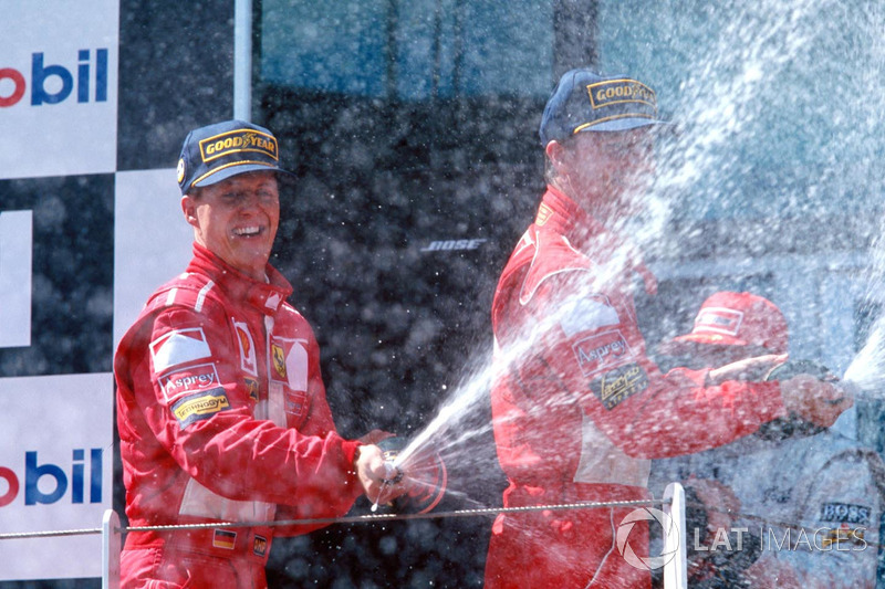 Podium: winner Michael Schumacher, Ferrari, second place Eddie Irvine, Ferrari, third place Mika Hak