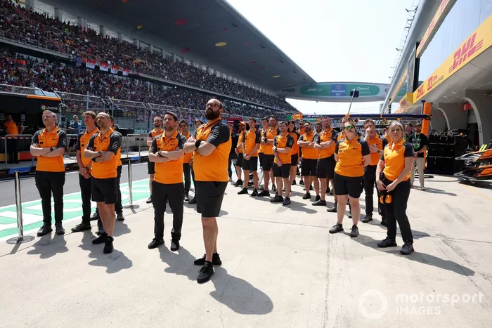 The McLaren team stand in tribute to the late Eddie Jordan