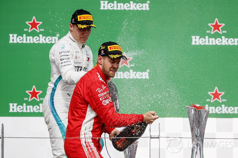 Valtteri Bottas, Mercedes AMG F1, 2nd position, and Sebastian Vettel, Ferrari, 1st position, celebra