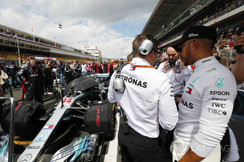 Lewis Hamilton, Mercedes AMG F1, talks to his engineer on the grid