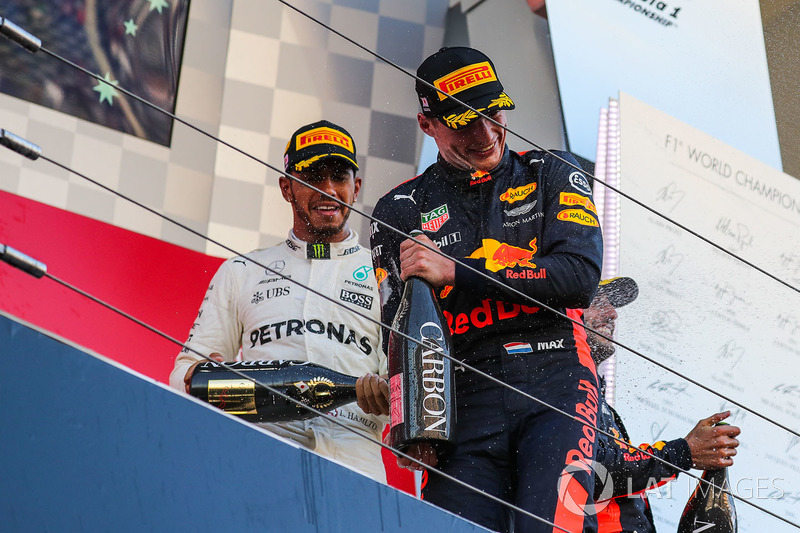 Lewis Hamilton, Mercedes AMG F1 and Max Verstappen, Red Bull Racing celebrate on the podium with the champagne