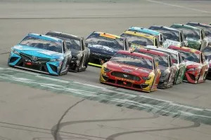 Ryan Blaney, Team Penske, Ford Mustang and Martin Truex Jr., Joe Gibbs Racing, Toyota Camry lead the field