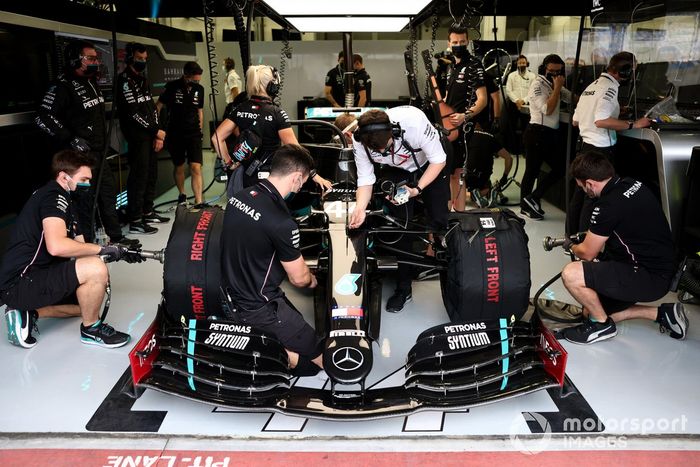 Mechanics work on the car of Lewis Hamilton, Mercedes F1 W11, in the garage