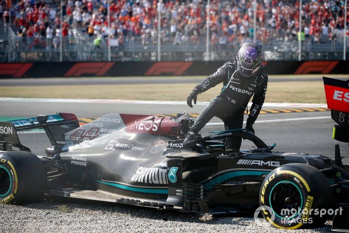 Lewis Hamilton, Mercedes, climbs out of his car after crashing out with Max Verstappen, Red Bull Racing