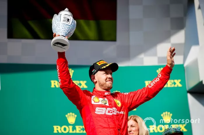 Il terzo classificato Sebastian Vettel, Ferrari, festeggia con il suo trofeo