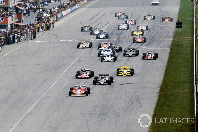 Gilles Villeneuve, Ferrari Ferrari 312T3 leads the original start of the race from pole sitter Mario Andretti, Lotus 79