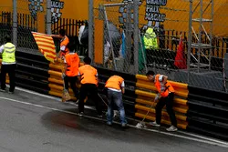 Marshalls try to clean the track