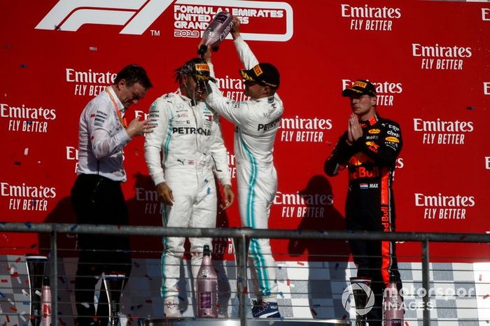 Valtteri Bottas, Mercedes AMG F1, 1ª posición, derrama Champagne sobre la cabeza del campeón del mundo de 2019 Lewis Hamilton, Mercedes AMG F1, 2ª posición, en el podio