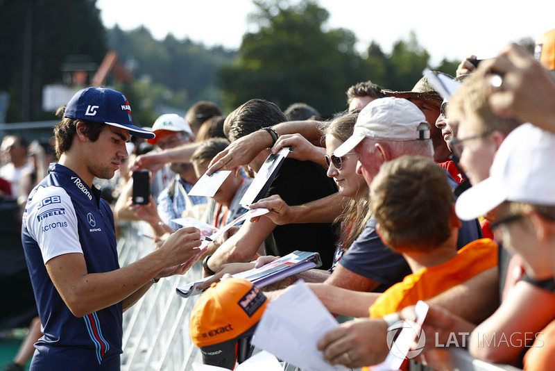 Lance Stroll, Williams Racing, signs autographs for fans