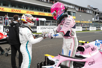 Esteban Ocon, Racing Point Force India, celebrates qualifying in third place with colleagues, with pole McLaren sitter Lewis Hamilton, Mercedes AMG F1