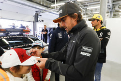 Fernando Alonso, McLaren, signs autographs for kids