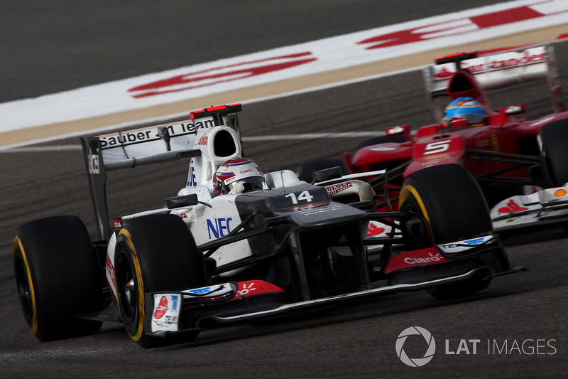 Kamui Kobayashi, Sauber C31, leads Fernando Alonso, Ferrari F2012