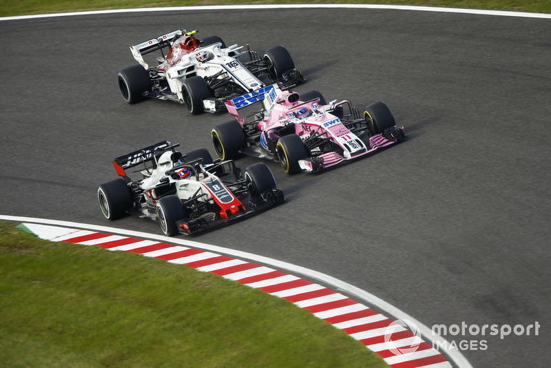 Romain Grosjean, Haas F1 Team VF-18, battles with Sergio Perez, Racing Point Force India VJM11 and Charles Leclerc, Sauber C37  