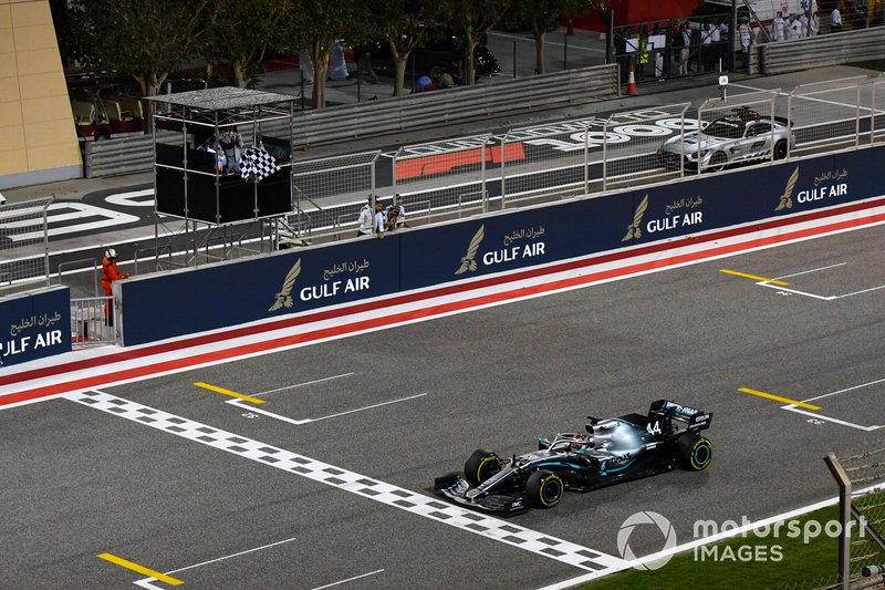 Lewis Hamilton, Mercedes AMG F1 W10, takes the chequered flag