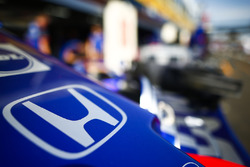 A Honda logo on the nose of a Toro Rosso in the pit lane