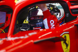 Kimi Raikkonen, Ferrari, in cockpit, reaches towards his halo