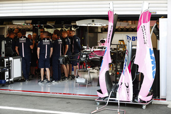 Mechanics gather in the Force India garage, next to the Sergio Perez Force India VJM11