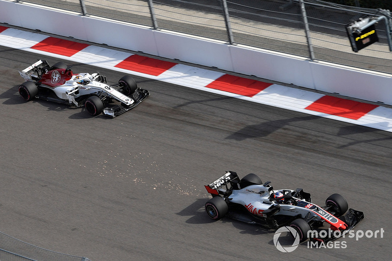 Romain Grosjean, Haas F1 Team VF-18 sparks and Marcus Ericsson, Sauber C37