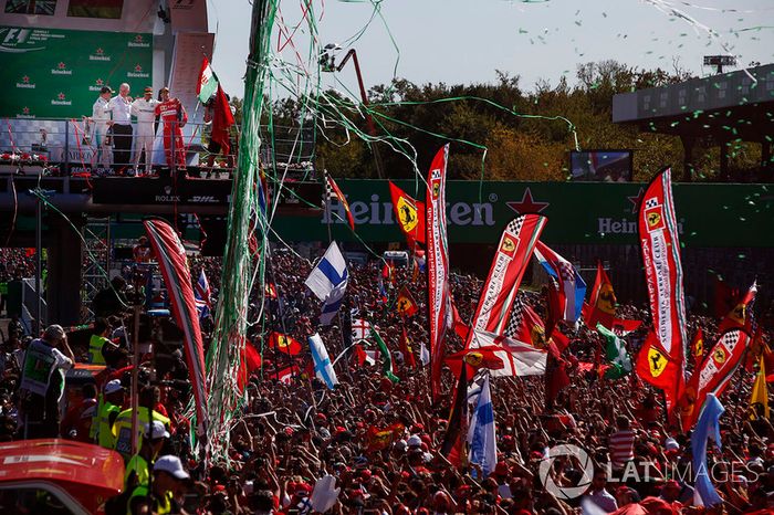  Confetti and streamers fall around the huge crowd of Ferrari fans gathered for the podium ceremony
