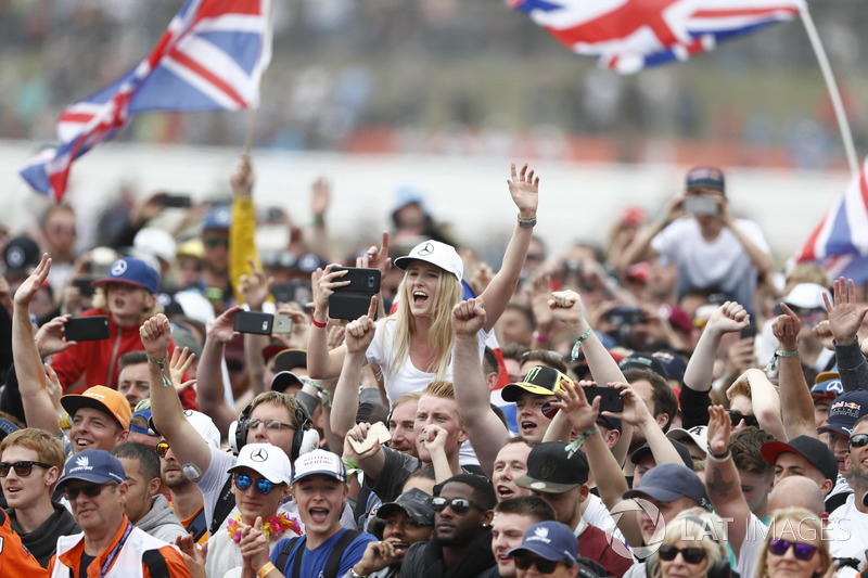 Fans cheer for Race winner Lewis Hamilton, Mercedes AMG F1, on the podium