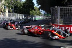 Kimi Raikkonen, Ferrari SF70H battles, Valtteri Bottas, Mercedes AMG F1 F1 W08  for position and collide at the start of the race
