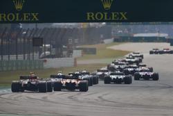 Daniel Ricciardo, Red Bull Racing RB14, chases a McLaren