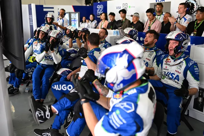 Racing Bulls team cheer in the garage