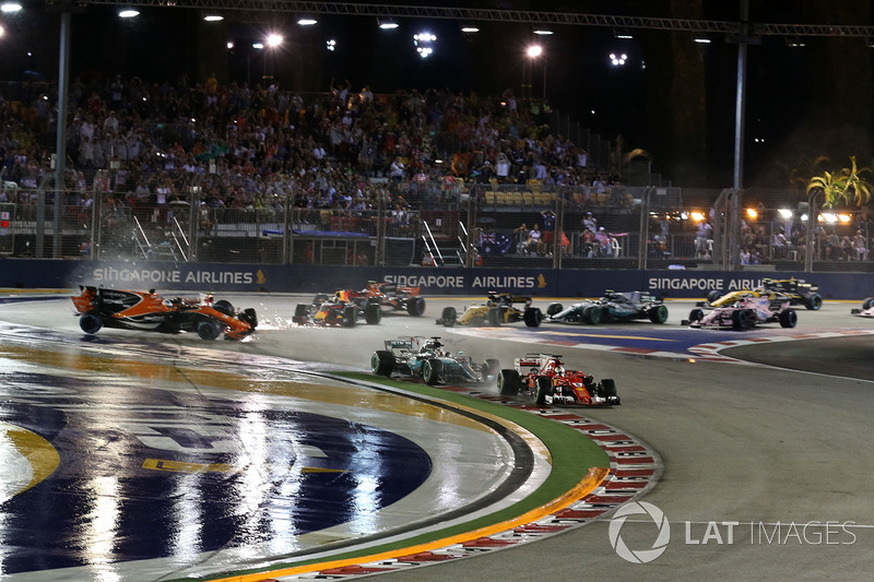 Sebastian Vettel, Ferrari SF70H leads at the start of the race as Fernando Alonso, McLaren MCL32, Kimi Raikkonen, Ferrari SF70H and Max Verstappen, Red Bull Racing RB13 crash in the background