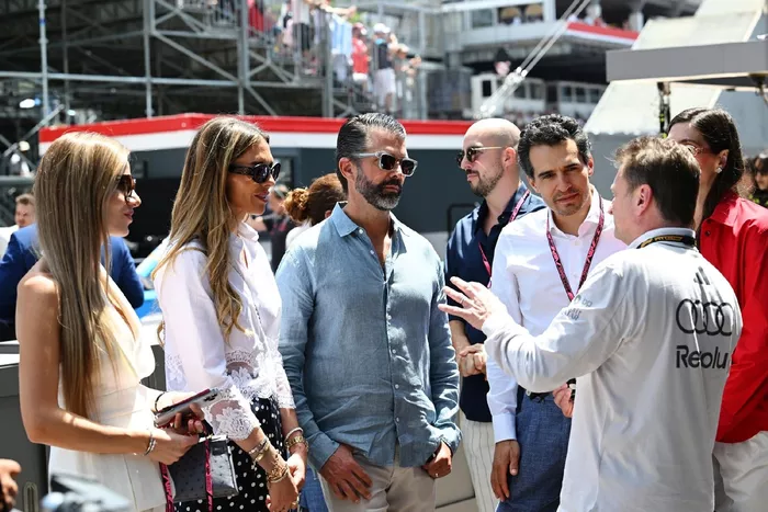 Allan McNish, Racing Director of Audi F1 Team talks to Donald Trump Jr and his wife Bettina Anderson