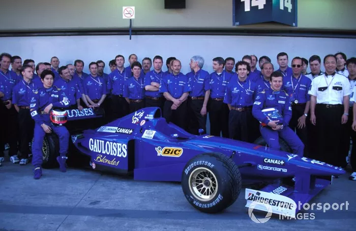 Prost team photo, with Olivier Panis and Shinji Nakano sat on a Prost JS45 Mugen-Honda

