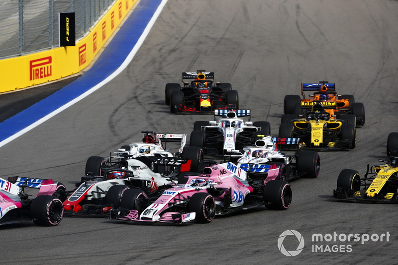 Romain Grosjean, Haas F1 Team VF-18, leads Sergio Perez, Racing Point Force India VJM11, Marcus Ericsson, Sauber C37, Sergey Sirotkin, Williams FW41, Lance Stroll, Williams FW41, Carlos Sainz Jr., Renault Sport F1 Team R.S. 18, Nico Hulkenberg, Renault Sport F1 Team R.S. 18, Fernando Alonso, McLaren MCL33, and Max Verstappen, Red Bull Racing RB14, at the start