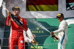 Sebastian Vettel, Ferrari celebrates by spraying champagne on the podium with Lewis Hamilton, Mercedes AMG F1
