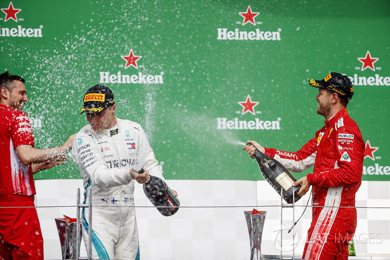 Valtteri Bottas, Mercedes AMG F1, 2nd position, and Sebastian Vettel, Ferrari, 1st position, celebra