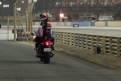 Race Retiree Daniel Ricciardo, Red Bull Racing gets a lift back to the pits on a motorbike