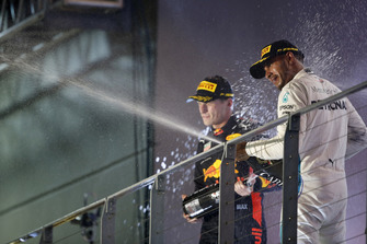 Max Verstappen, Red Bull Racing, 2nd position, and Lewis Hamilton, Mercedes AMG F1, 1st position, spray Champagne on the podium