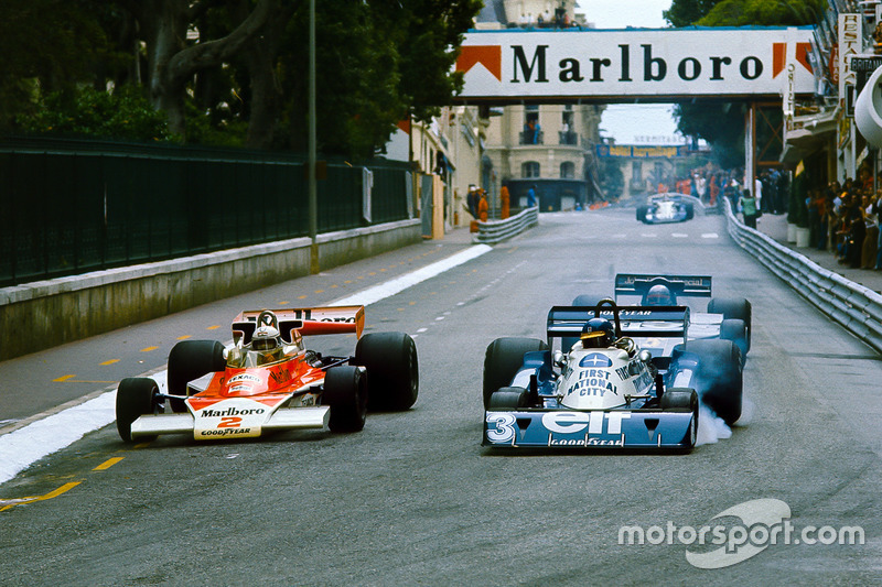 Jochen Mass, McLaren M23 Ford, overtakes Ronnie Peterson, Tyrrell P34 Ford, with Mario Andretti, Lot