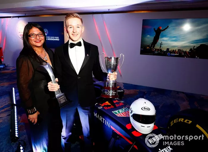 Il vincitore dell'Aston Martin Autosport BRDC Young Driver Award Johnathan Hoggard festeggia con gli amici e la famiglia con il trofeo e l'assegno vicino alla Red Bull Racing RB15