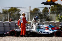 Lance Stroll, Williams FW41, climbs out of his car and is assisted by marshals after spinning into the gravel