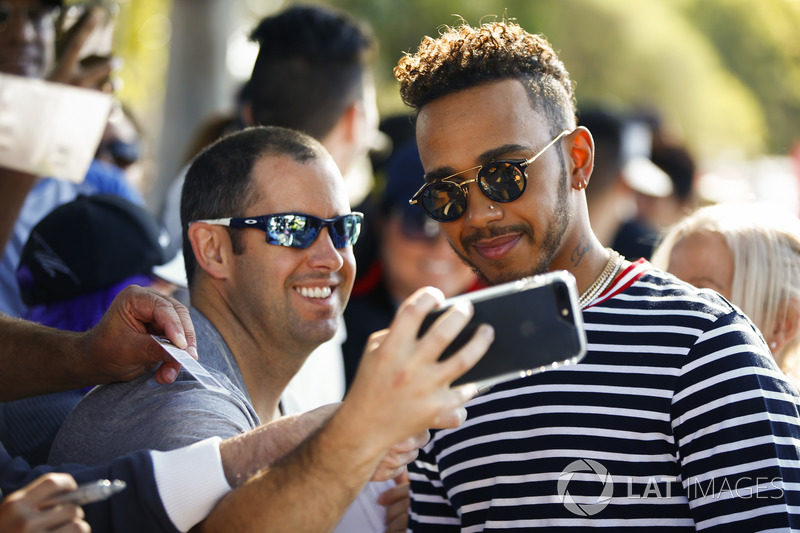 Lewis Hamilton, Mercedes AMG F1, takes a selfie with a fan