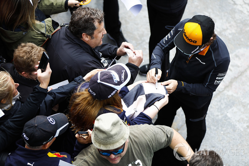 Fernando Alonso, McLaren, signs autographs for fans