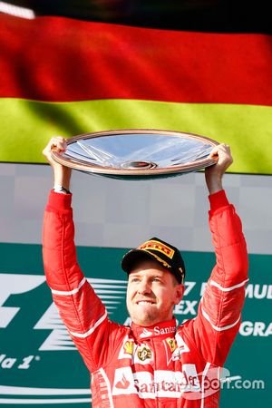 Sebastian Vettel, Ferrari, 1st Position, celebrates victory on the podium with his trophy