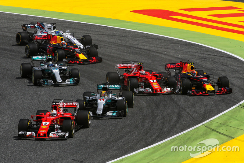 Sebastian Vettel, Ferrari SF70H leads at the start of the race as Kimi Raikkonen, Ferrari SF70H and Max Verstappen, Red Bull Racing RB13 collide