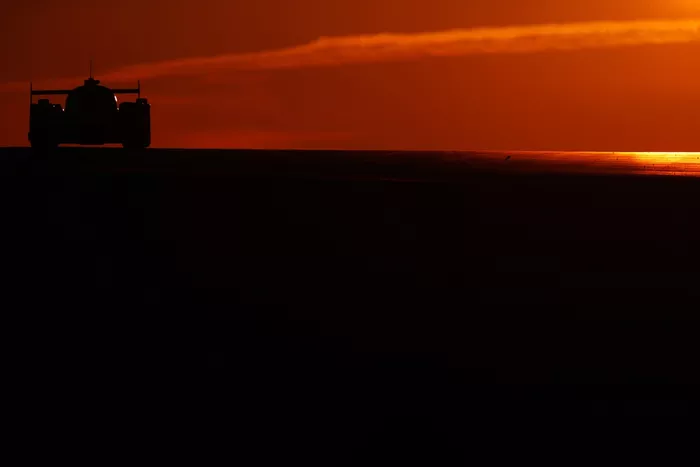 A driver passes under the Dunlop Bridge at sunrise