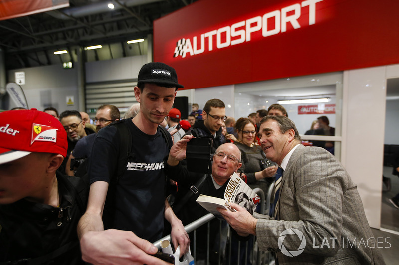 Nigel Mansell signs autographs for fans
