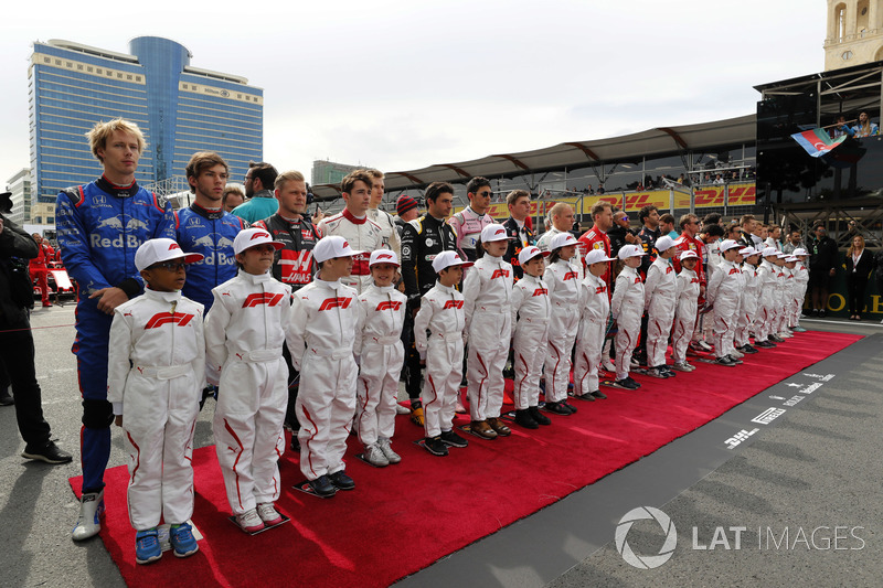 The drivers on the grid for the national anthem with their mascots