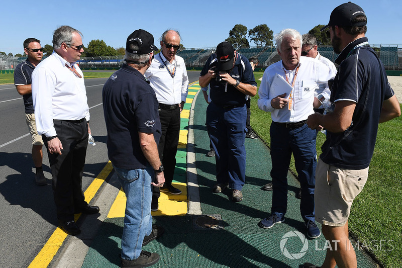 Charlie Whiting, FIA Delegate inspects the track and kerbs