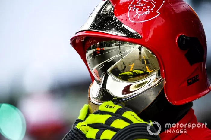 El reflejo de Max Verstappen, Red Bull Racing RB15, en el casco de un comisario