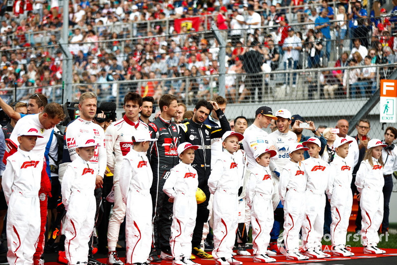 Sebastian Vettel, Ferrari, Kevin Magnussen, Haas F1 Team, Charles Leclerc, Sauber, Romain Grosjean, Haas F1 Team, Carlos Sainz Jr., Renault Sport F1 Team, Stoffel Vandoorne, McLaren, Pierre Gasly, Scuderia Toro Rosso, and the other drivers join the grid kids for the national anthem prior to the start